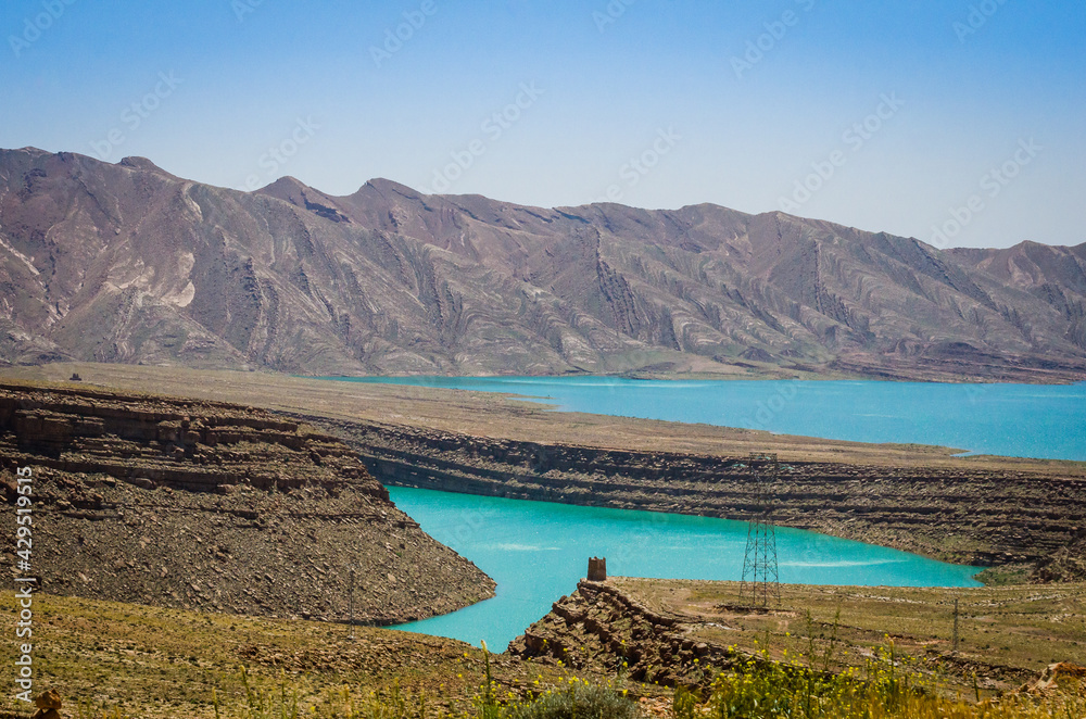 Turquoise blue water in Barrage Al-Hassan Addakhil in dry nature near Errachidia in Morocco