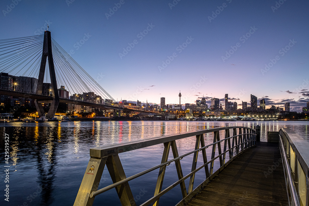 small jetty with cityscape in background