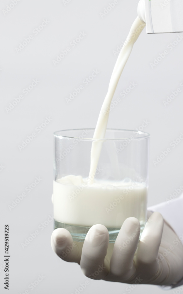 full glass of milk, with gloves, white background full glass of milk, with gloves, white background