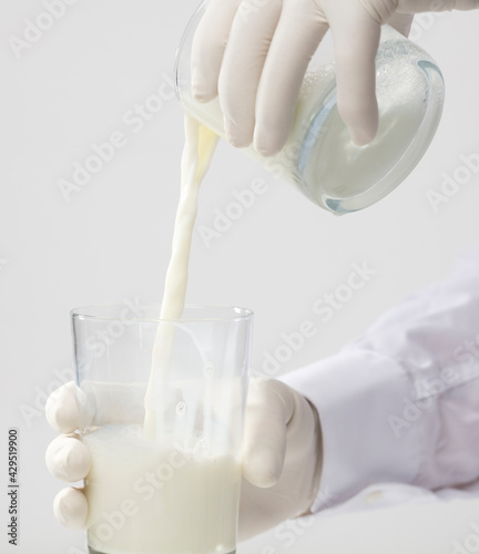 full glass of milk, with gloves, white background