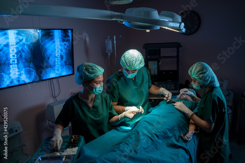 Medical Team Performing Surgical Operation in Modern Operating Room,Healthcare workers in the Coronavirus Covid 19 pandemic,surgery,Medicine and people concept