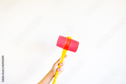 Hand holding a plastic hammer