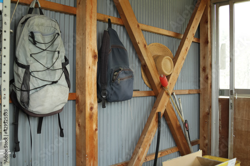 Nagano, Japan, 22-04-2021 , Backpacks hanging on a wall  Inside of a shed in an apple field. photo