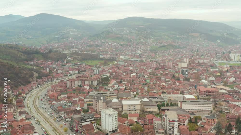 Aerial cityscape of Novi Pazar located in the Raska District of southwestern Serbia.Mountains in fog in the background Aerial cityscape of Novi Pazar located in the Raska District of southwestern Serbia.Mountains in fog in the background