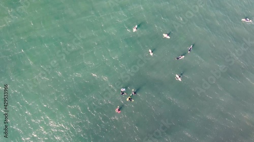 Drone pan shot of surfers and bodyboarders floating and waiting in Pacific Ocean Central Coast NSW Australia 3840x2160 4K photo