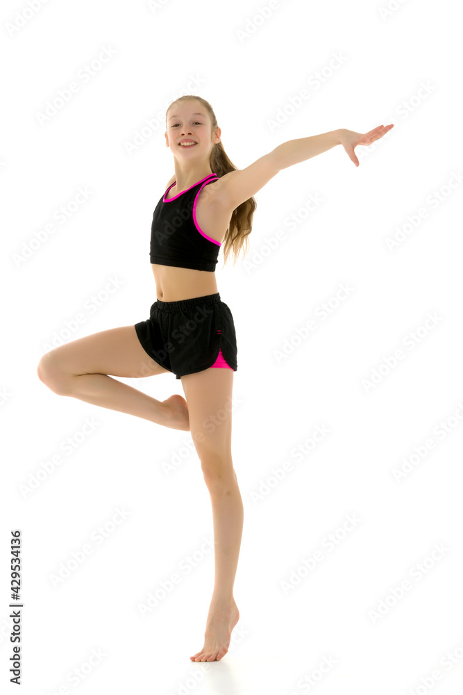 Gymnast Girl Balancing on One Leg Wearing Black Tank Top and Sho