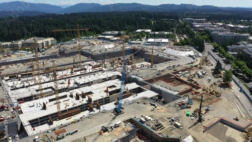 Cinematic aerial drone footage of the crane forest at the development of the new campus fort the Microsoft Corporate Headquarters in Overlake and Redmond, Washington, near Bellevue, Seattle photo