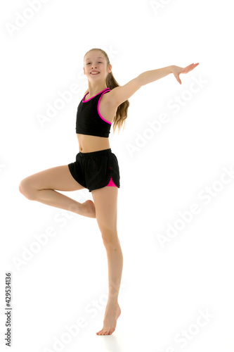 Gymnast Girl Balancing on One Leg Wearing Black Tank Top and Sho © lotosfoto