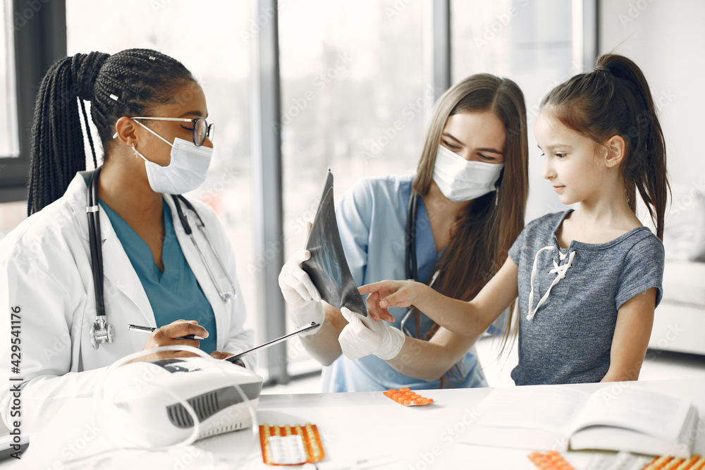 Fototapeta premium Doctor examines a little girl in hospital