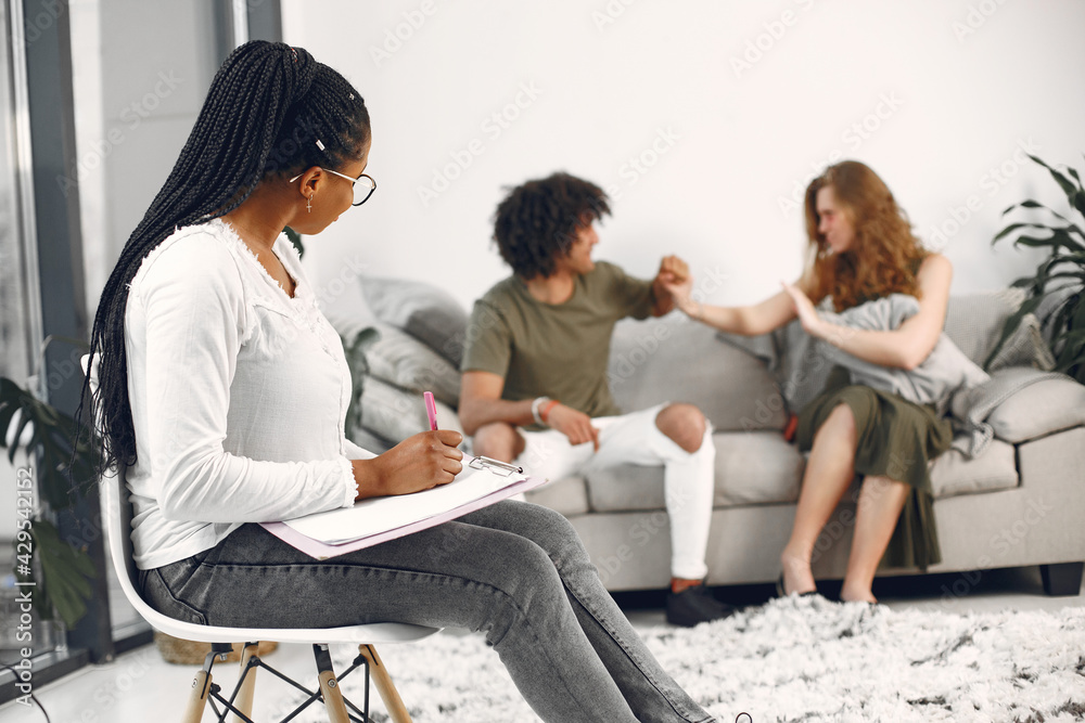 Casual couple man and woman having conversation with psychologist Casual couple man and woman having conversation with psychologist