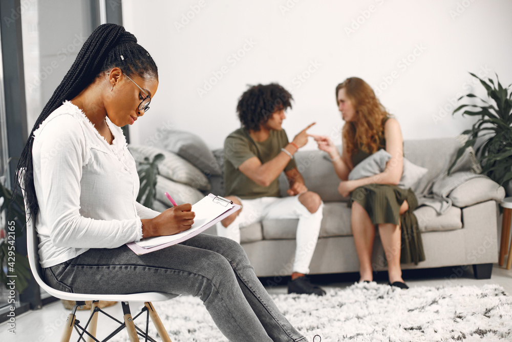 Casual couple man and woman having conversation with psychologist Casual couple man and woman having conversation with psychologist
