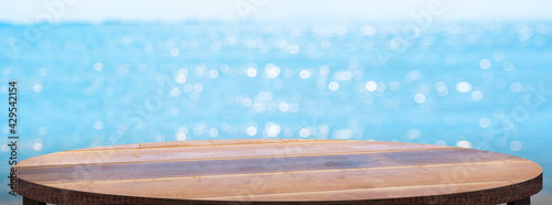 Canvas Print Empty round wood table with summer blue sea blur background