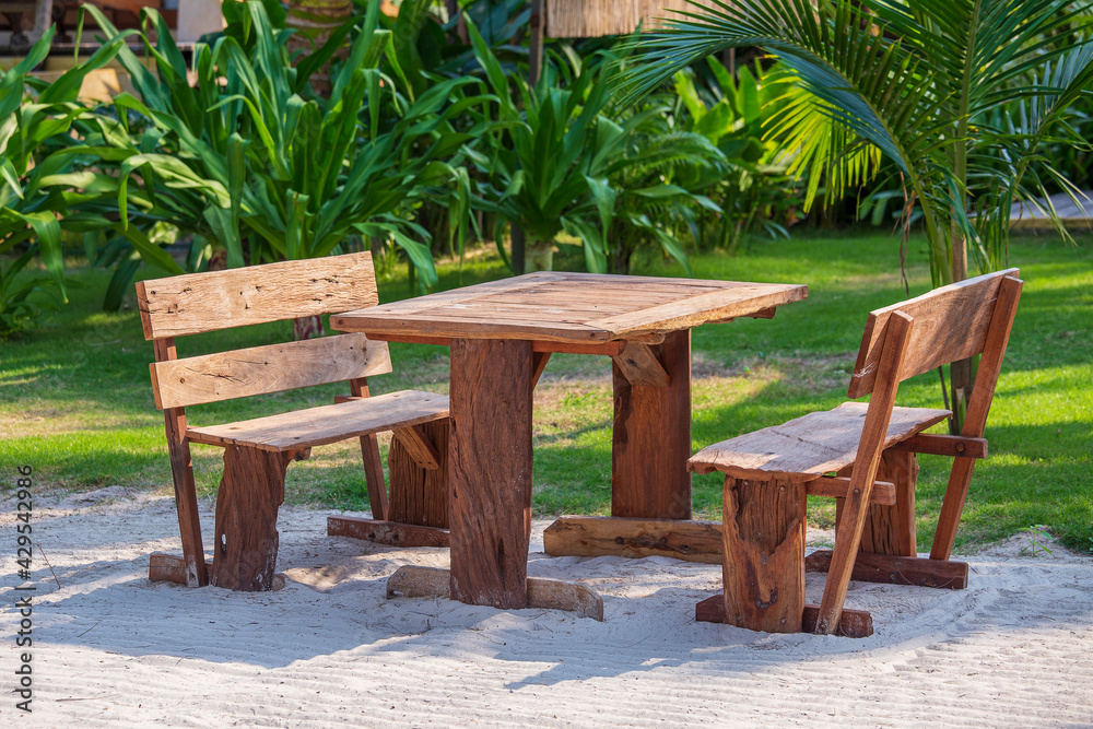 Wooden cafe table and chairs on a tropical beach, Thailand. Holiday and summer concept