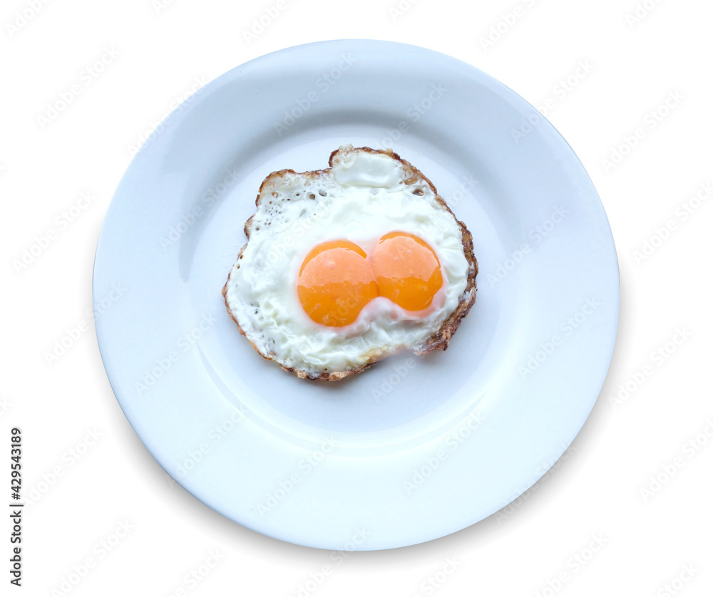 Twin Fried Eggs on white plate isolated on white background. Twin Fried Eggs on white plate isolated on white background.