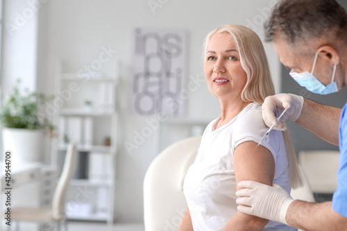 Doctor vaccinating patient ...