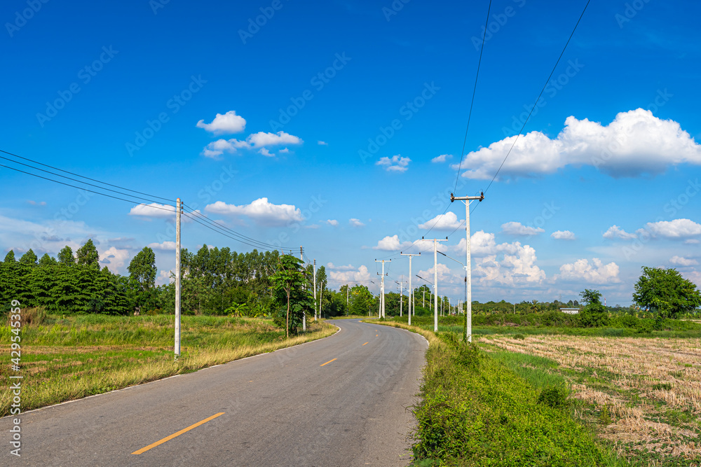 view of asphalt roads countryside Beside with spring nature and tree green in fluffy clouds blue sky daylight background.
