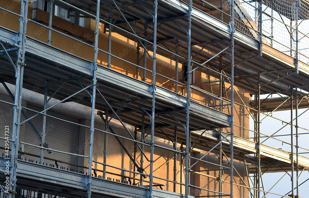 a mansion with a scaffolding for renovation a mansion with a scaffolding for renovation
