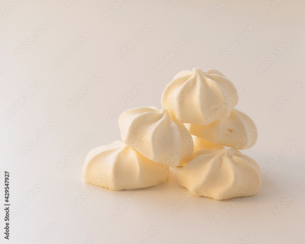 a bunch of cream meringues on a light background a bunch of cream meringues on a light background