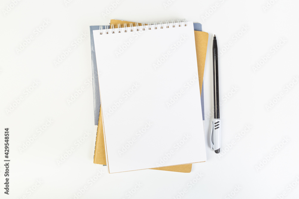 top view of an open notebook with a pen on a gray background, school notebooks with a spiral spring, office notepad. desktop concept, learning top view of an open notebook with a pen on a gray background, school notebooks with a spiral spring, office notepad. desktop concept, learning
