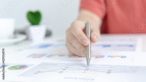 Asian women are analyzing graphs, market data and assessing investment risks, Working at home during the outbreak of the virus or social spacing, Refraining from spreading germs.
