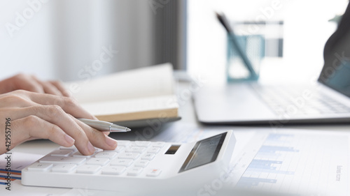 Accounting businesswomen are calculating income-expenditure and analyzing real estate investment data, Dedicated to the progress and growth of the company, Financial and tax systems concept.