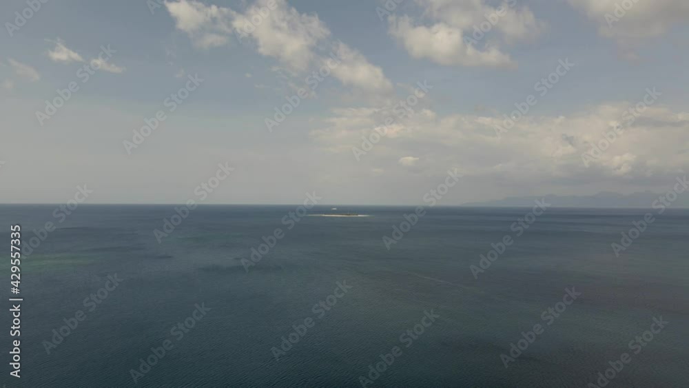 Aerial view on the sea from drone of a little tropical island in open sea. Small wild beach in Indian ocean with turquoise water. Lombok Bali, Indonesia High quality 4k footage Aerial view on the sea from drone of a little tropical island in open sea. Small wild beach in Indian ocean with turquoise water. Lombok Bali, Indonesia High quality 4k footage
