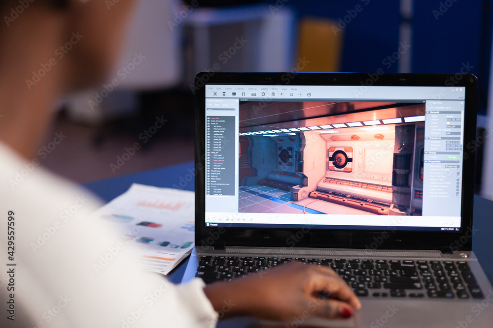 Black freelancer game developer typing on keyboard developing new level of  videogame. African pro player testing game over level interface in midnight  from business office using laptop. Stock Photo | Adobe Stock