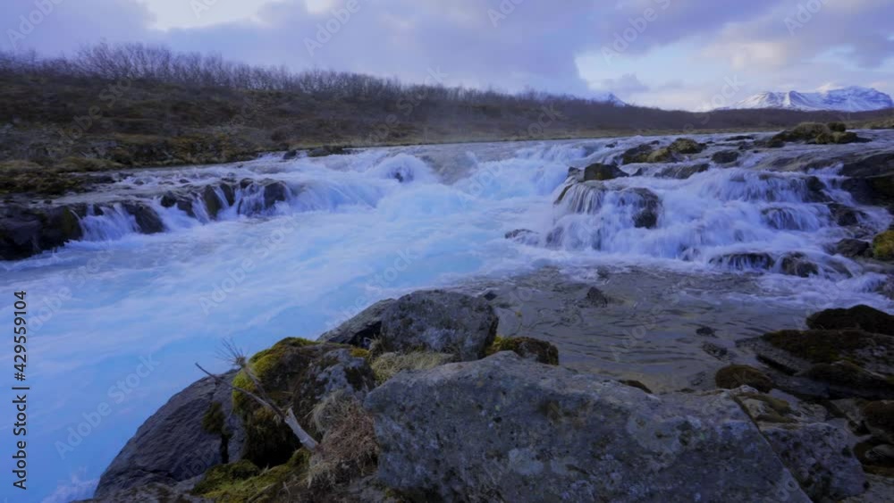 Stunning shot of floating Water at waterfall edge surrounded by rocks in nature. Pan shot. Stunning shot of floating Water at waterfall edge surrounded by rocks in nature. Pan shot.