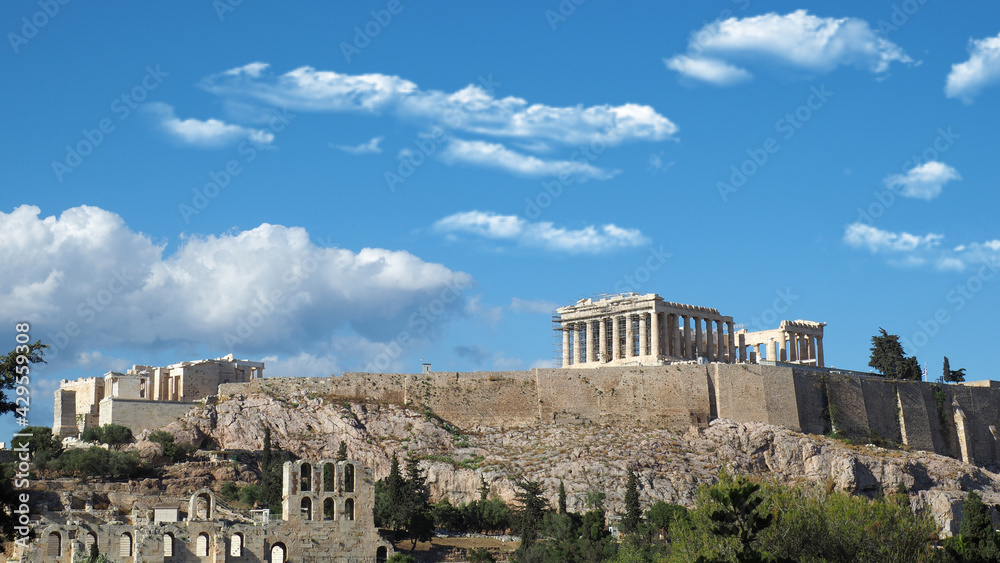 Acropolis hill and the Parthenon, Attica, Greece. Famous old Acropolis hill is a top landmark of Athens on a spring cloudy morning with deep blue sky