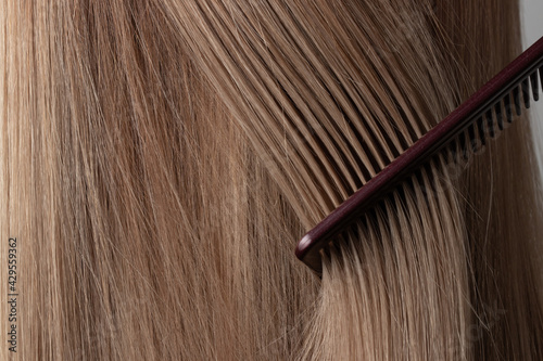 Brushing hair with a comb. Long, hair structure, strands, hairdresser, care, styling