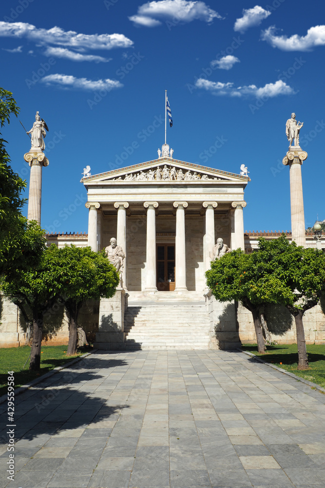 Fototapeta premium Beautiful neoclassic Academy of Athens public landmark building with beautiful spring clouds and deep blue sky, Athens historic centre, Attica, Greece