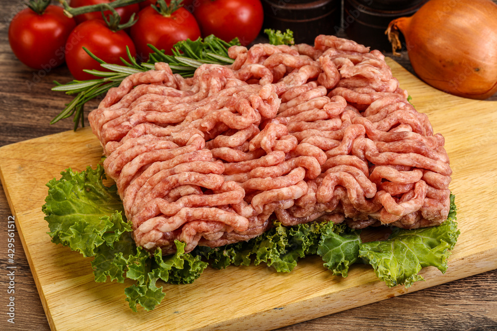 Raw pork minced meat over board Raw pork minced meat over board