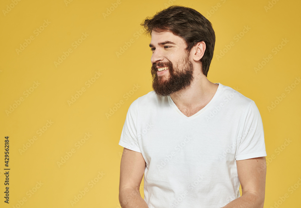 portrait of a man in a white t-shirt on a yellow background cropped view Copy Space portrait of a man in a white t-shirt on a yellow background cropped view Copy Space