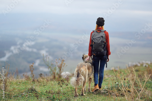 Wallpaper Mural woman hiker with backpack with dog in the mountains travel friendship Torontodigital.ca