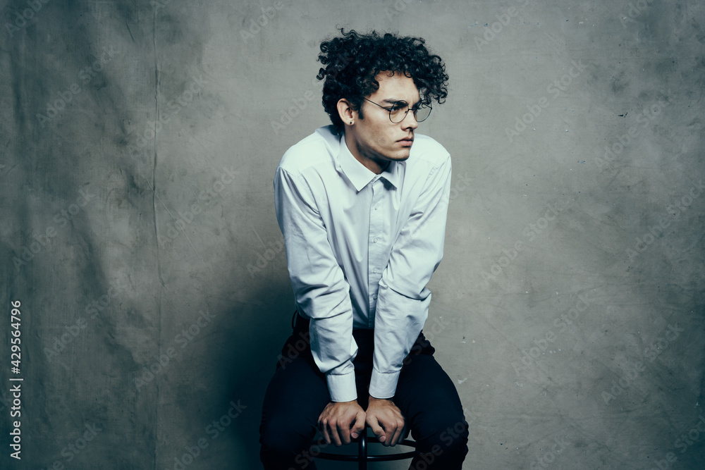 curly hair young man in shirt classic suit photography studio model on fabric background