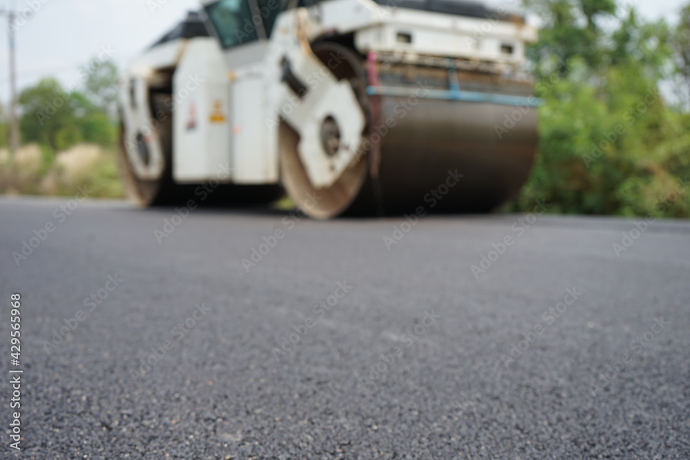 The image is blurred in the construction of asphalt road. The image is blurred in the construction of asphalt road.
