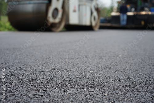 The image is blurred in the construction of asphalt road.