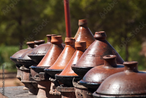 Row of Moroccan clay tagines -  traditional cooking vessels photo