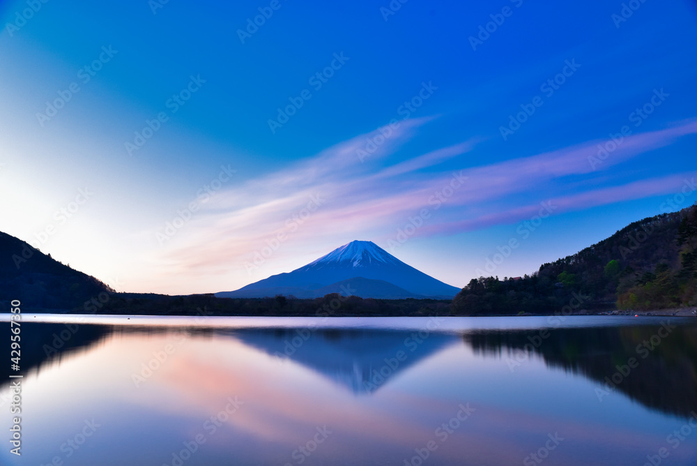 Mt. Fuji reflected on the surface of the lake at sunrise