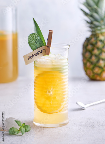 Ginger Ale, Pineapple and orange mocktail on stone concrete background. Selective focus, copy space.