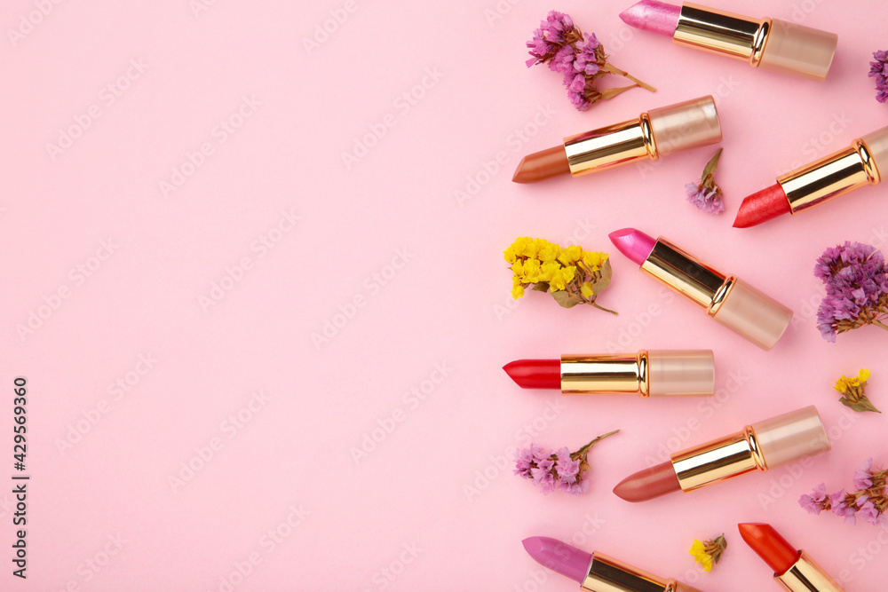 Lipstick with beautiful flowers on pink background with copy space Lipstick with beautiful flowers on pink background with copy space