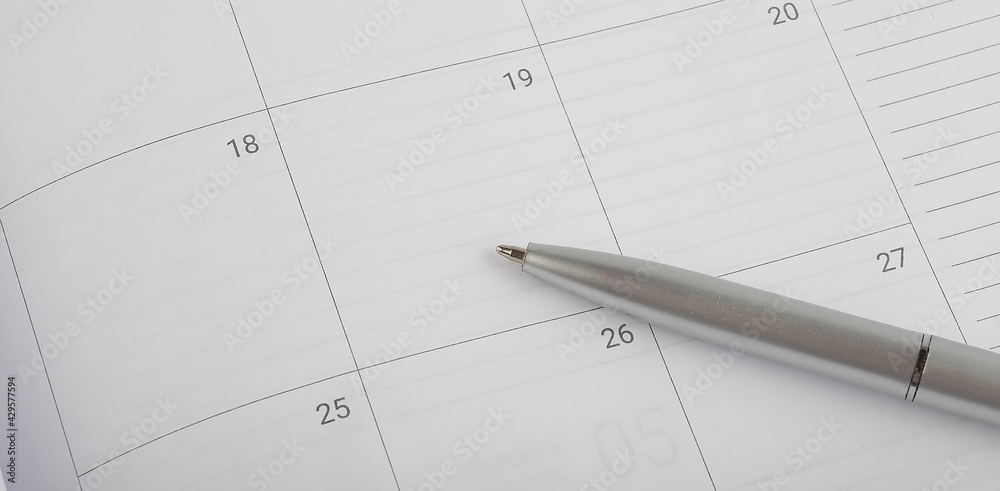 Calendar planner with silver pen, copy space Calendar planner with silver pen, copy space