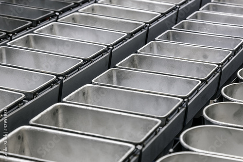metal molds on the conveyor for baking bread