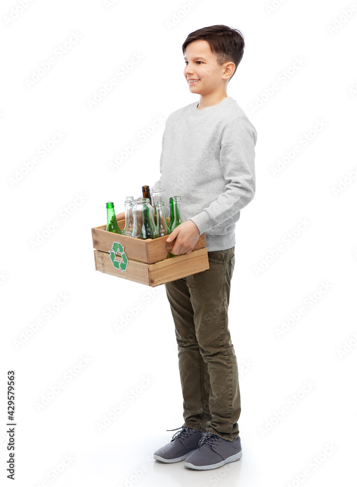 recycling, waste sorting and sustainability concept - smiling boy holding wooden box with glass bottles and jars over white background recycling, waste sorting and sustainability concept - smiling boy holding wooden box with glass bottles and jars over white background