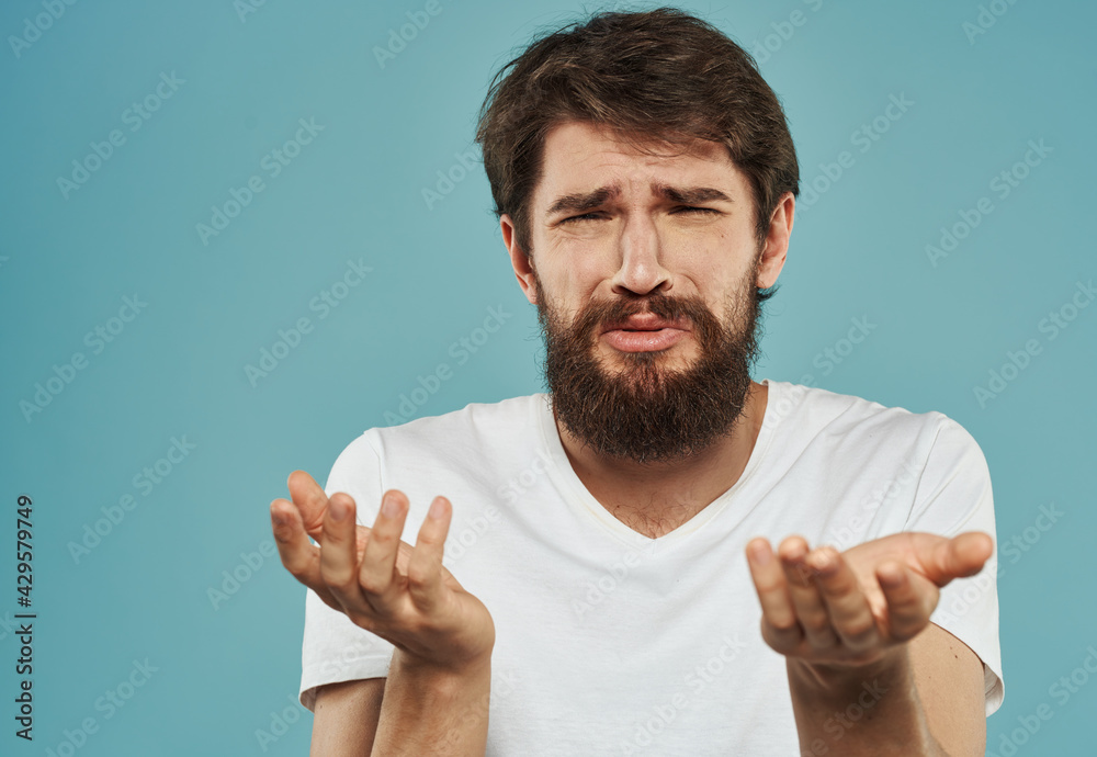 Emotional guy gesturing with his hands on a blue background Copy Space Model cropped view Emotional guy gesturing with his hands on a blue background Copy Space Model cropped view