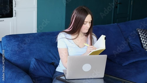 Girl notes online lecture, distance learning for students