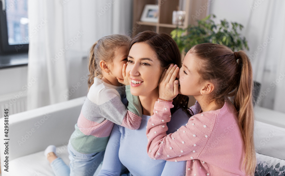 people, family and concept - happy mother and two daughters gossiping at home people, family and concept - happy mother and two daughters gossiping at home