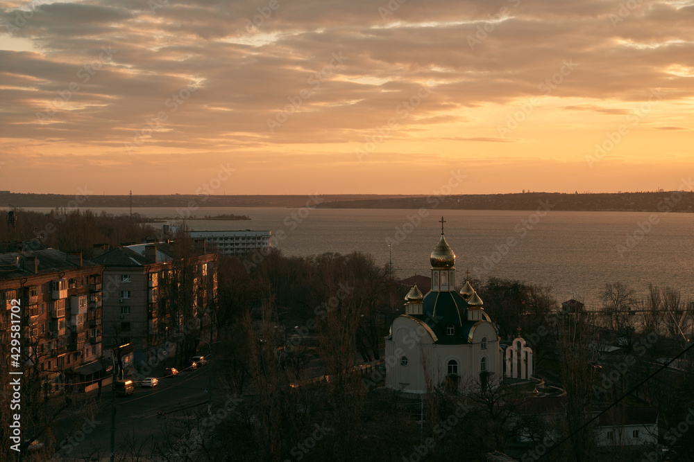 astern Orthodox Church on the river. Sky moving with god rays. Skylapse of the church with golden domes. Dome of the church reflecting floating sky