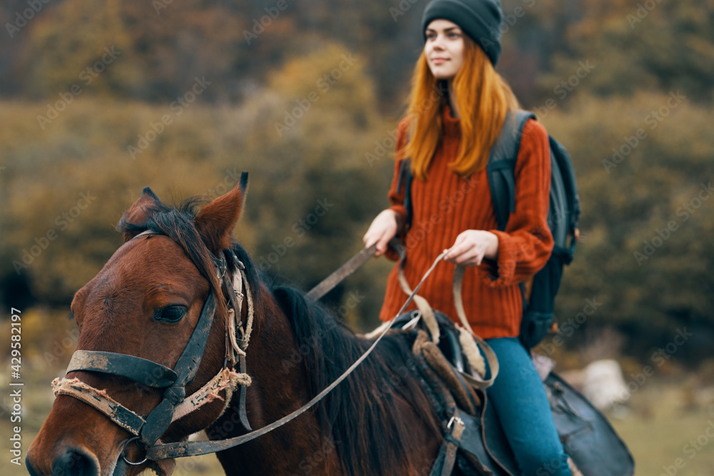 woman hiker riding a horse in the mountains walk fresh air travel