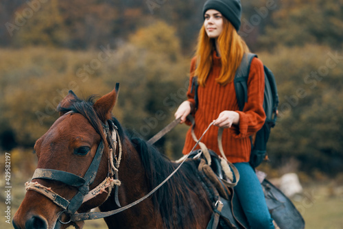 woman hiker riding a horse in the mountains walk fresh air travel